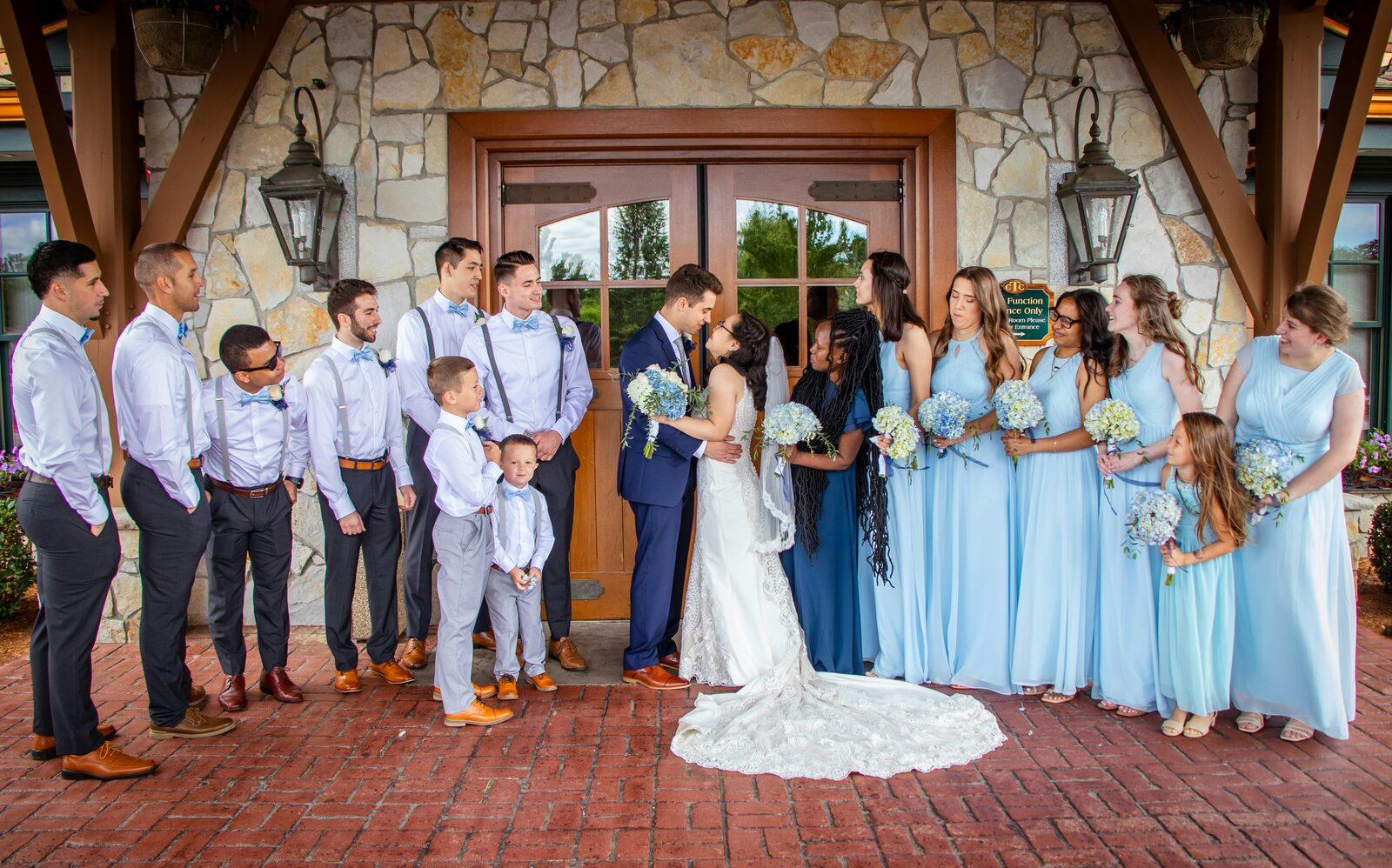 Massachusetts bride and groom kissing with their wedding party after a stress-free prenup process