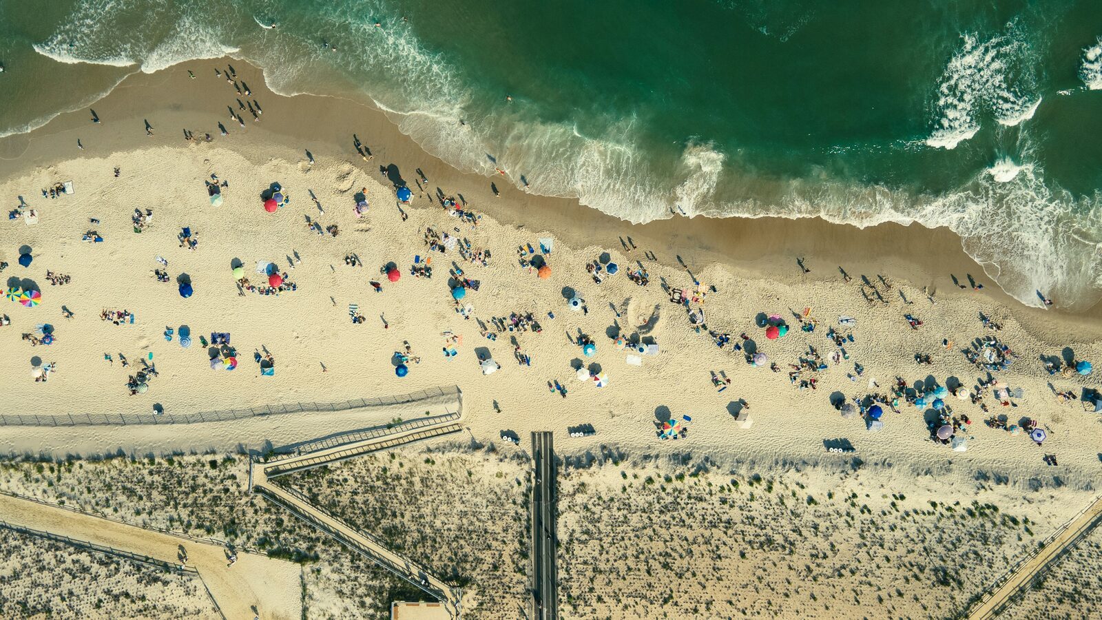 Aerial view of a New Jersey shore beach and boardwalk on a summer day