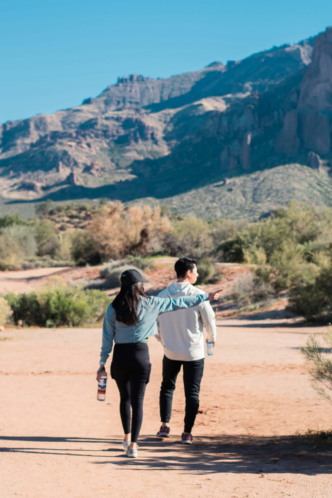 Engaged Arizona couple hiking in the Superstition Mountains while planning their prenup