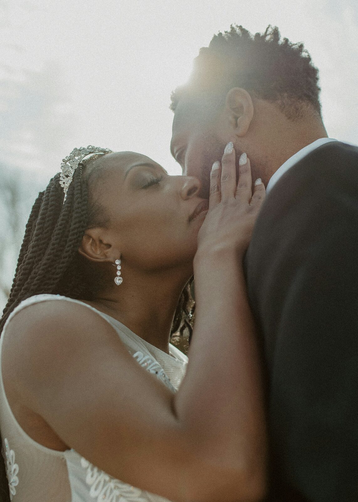 Michigan couple sharing an intimate kiss at sunset after finalizing their prenup