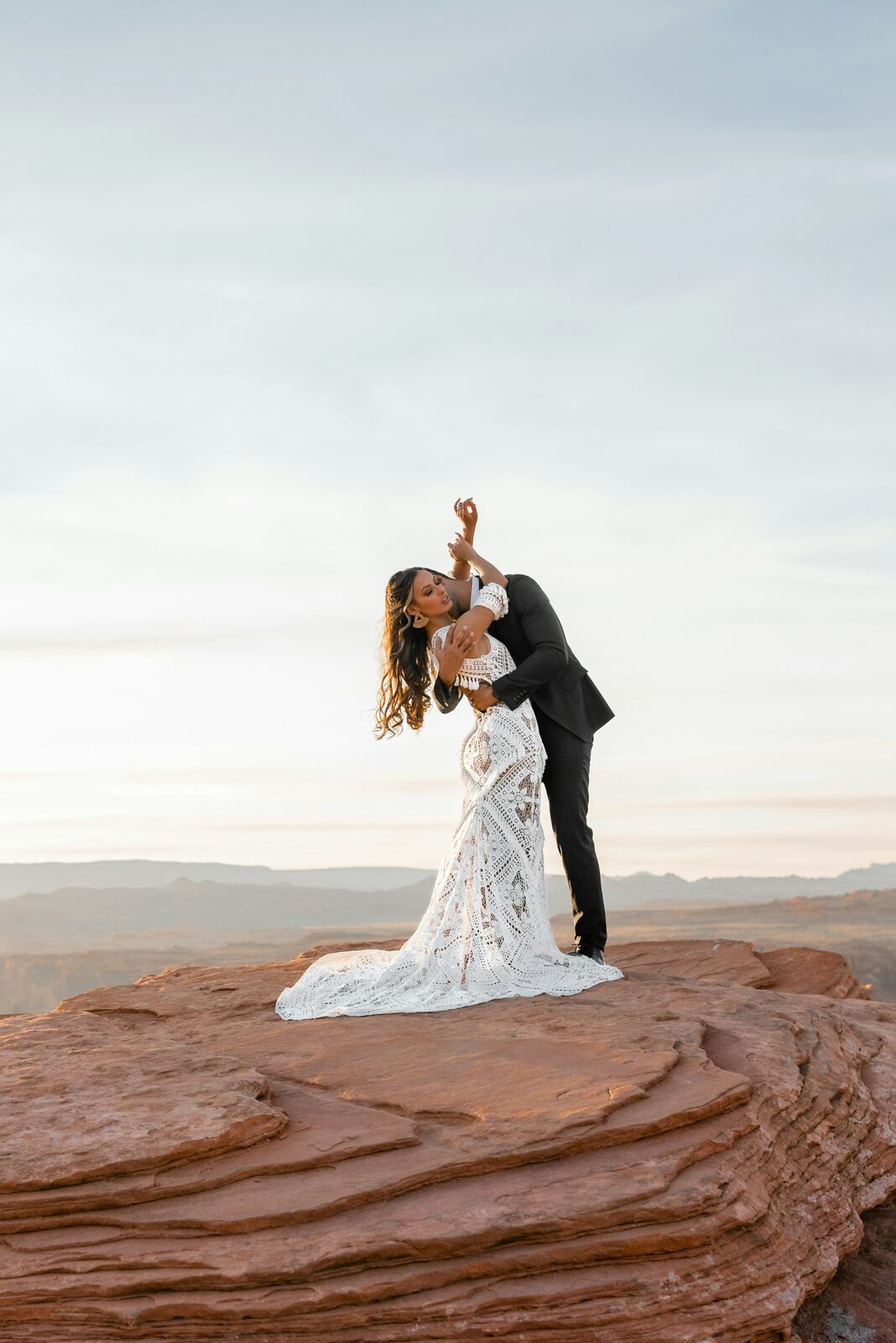 Arizona bride and groom in a sunset dip pose at Horseshoe Bend to celebrate their engagement