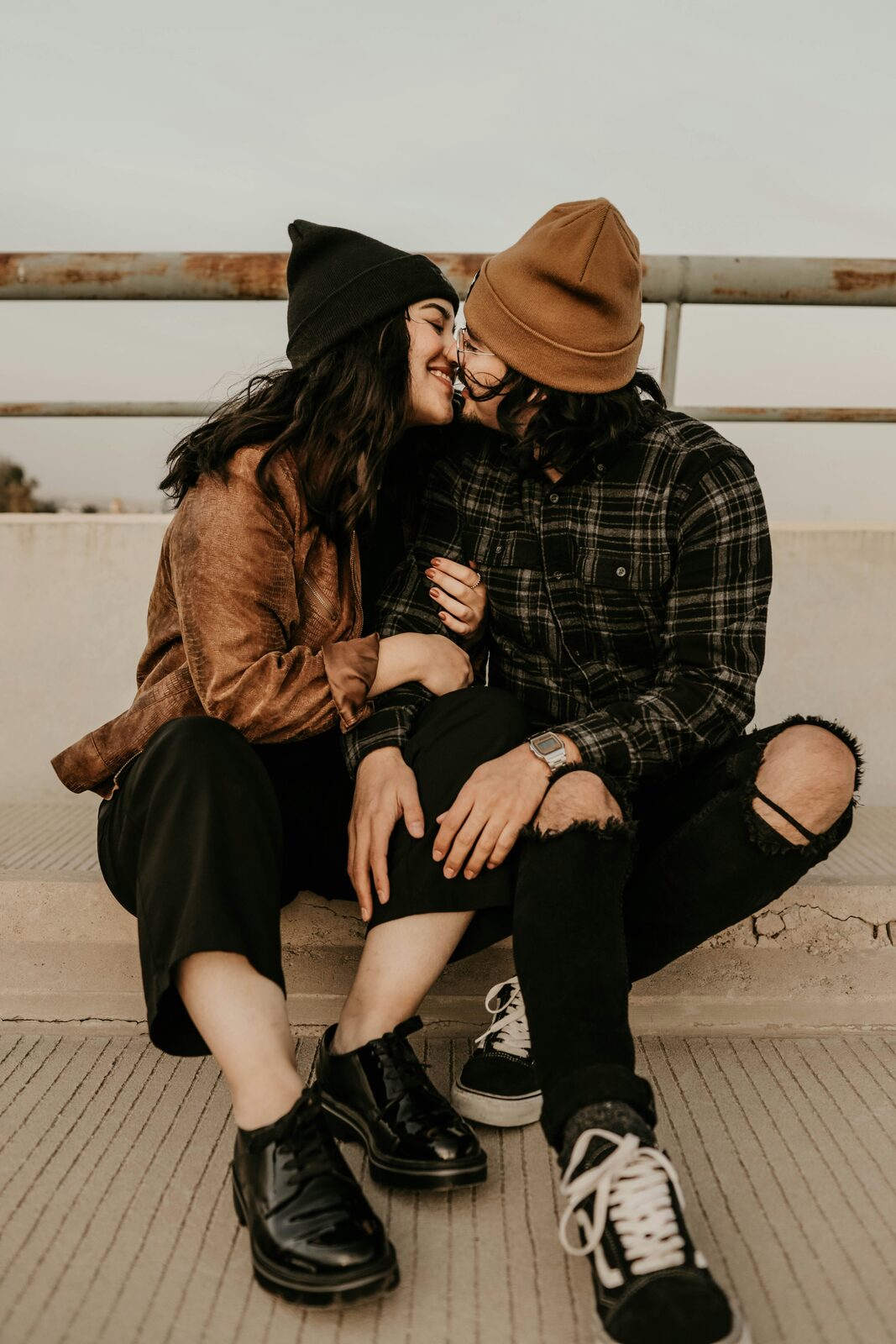 Virginia couple touching noses on a rooftop in cozy fall flannel layers