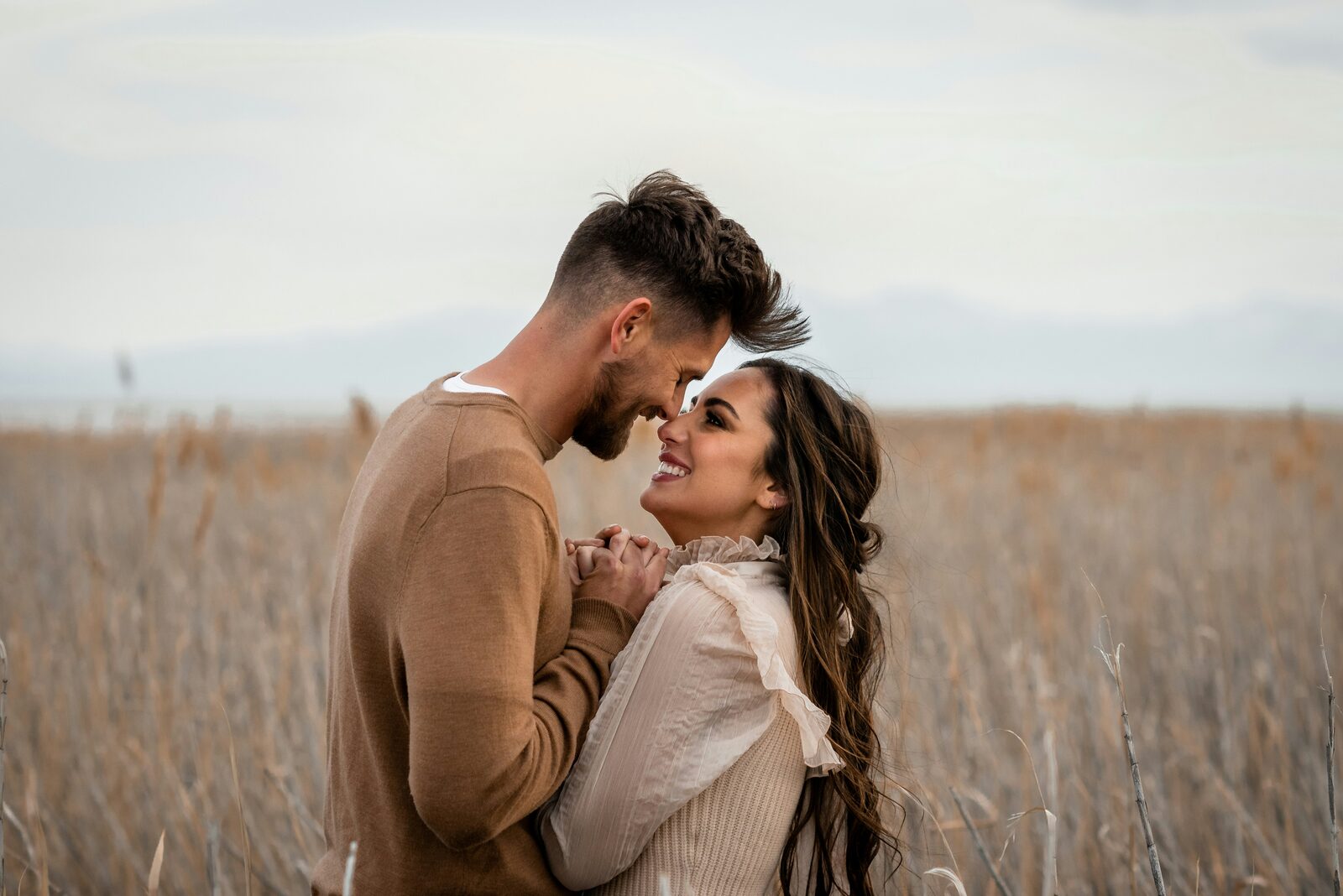 West Virginia couple with foreheads together in a wheat field after a stress-free prenup process
