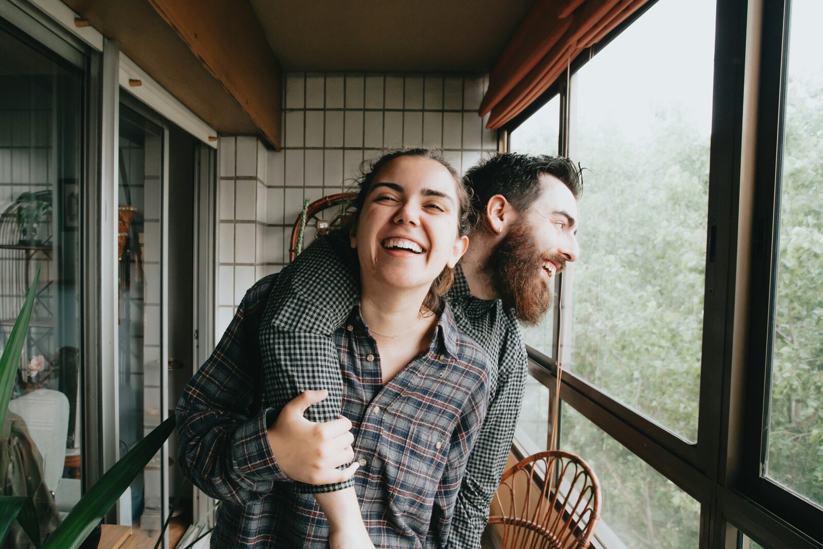West Virginia couple laughing on their balcony in a candid moment after completing their prenup