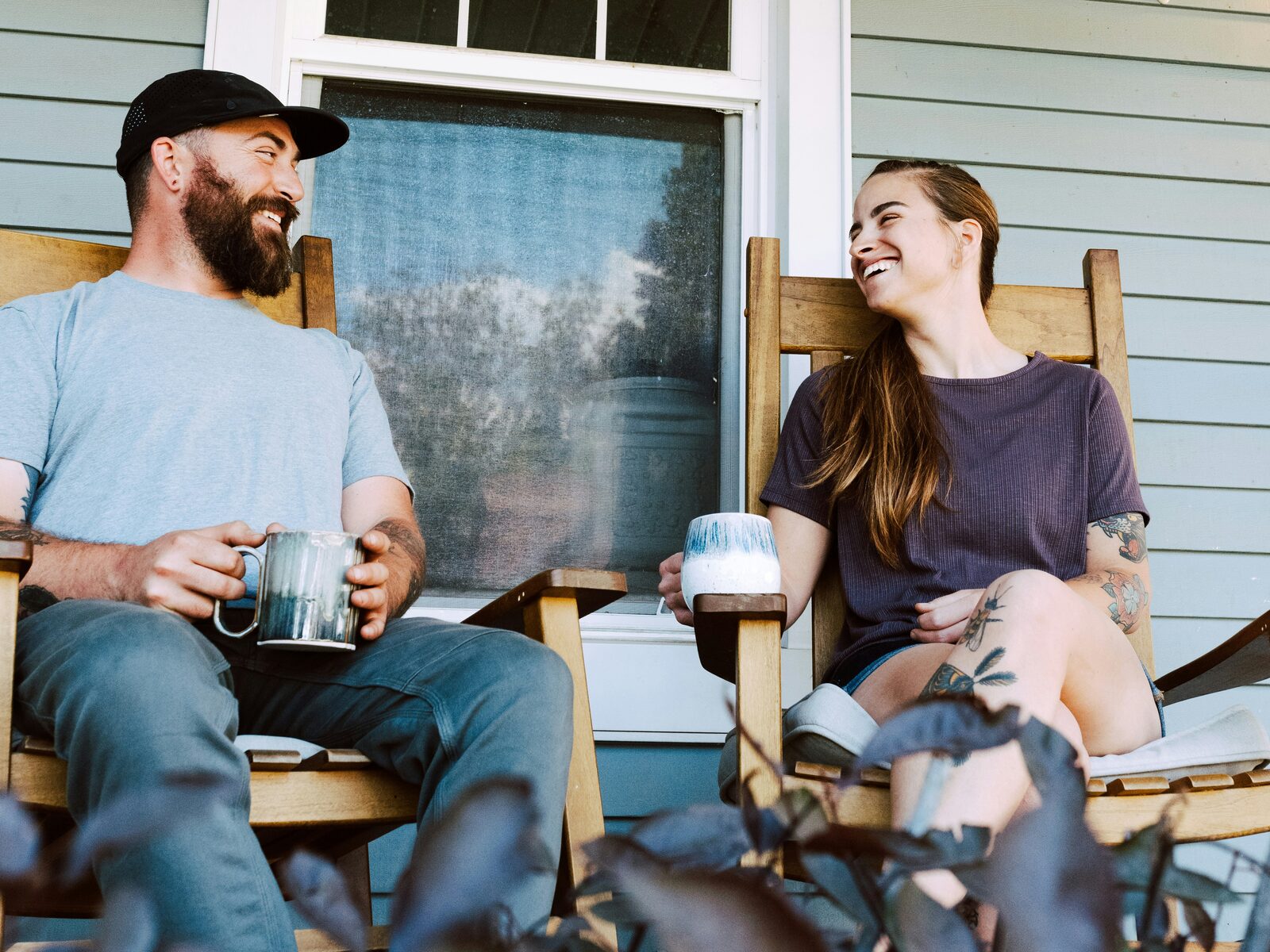 West Virginia couple laughing on a porch with coffee after completing their prenup
