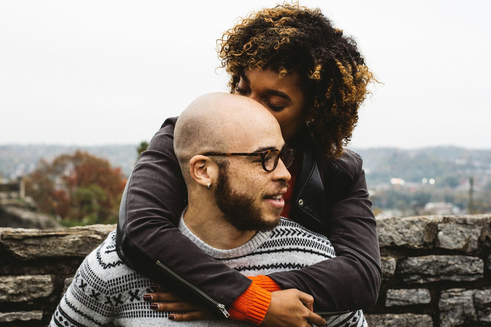 Engaged West Virginia couple embracing while overlooking the hills, exploring their prenup options