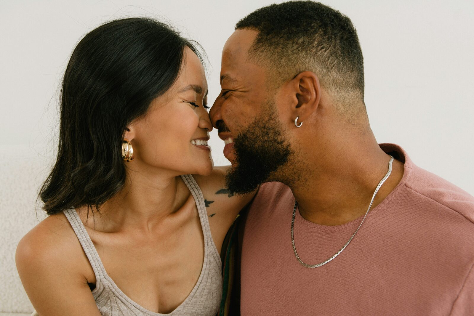 Engaged Georgia couple together, foreheads touching, exploring their prenup options