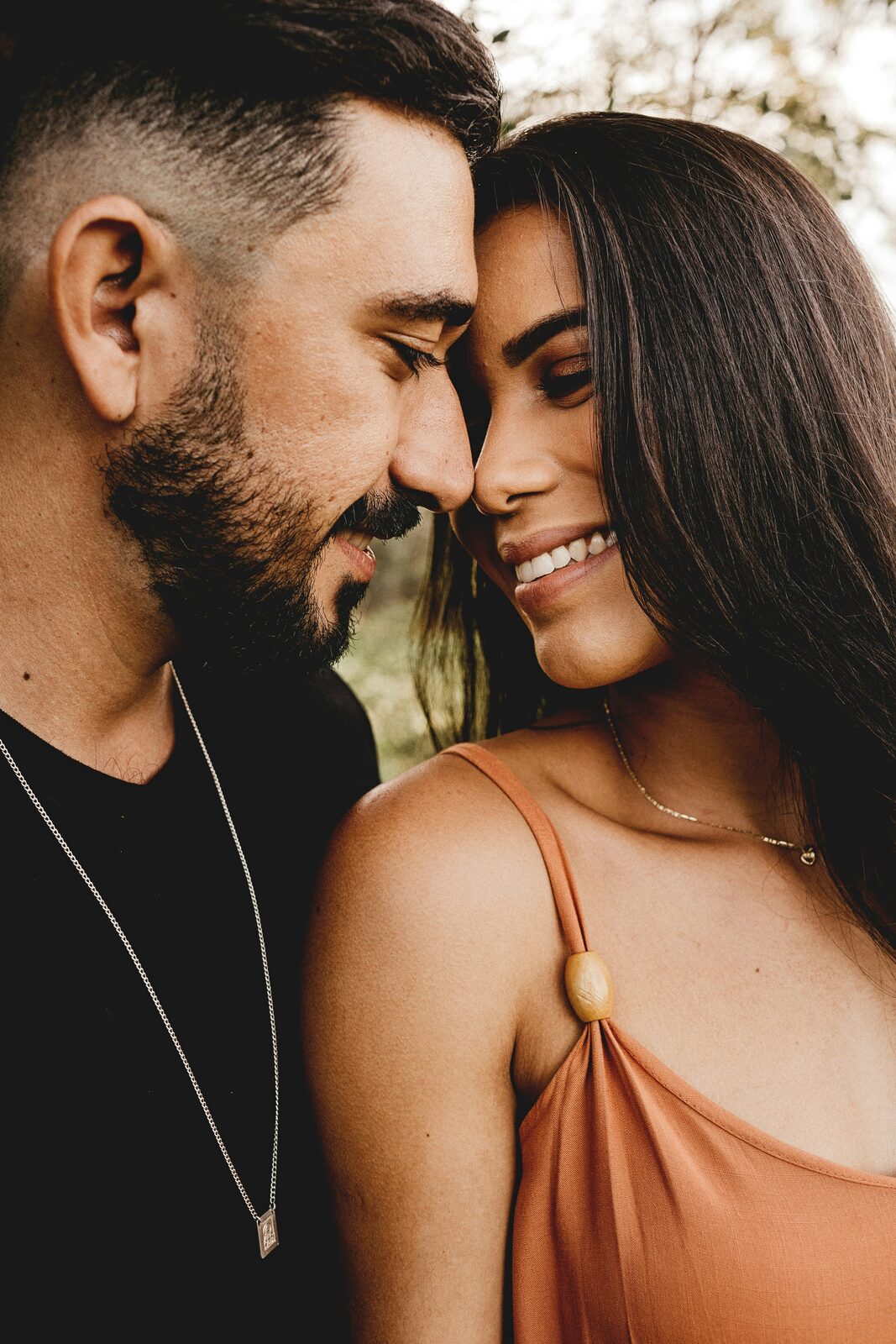 Engaged Oklahoma couple touching foreheads at golden hour, exploring their prenup options