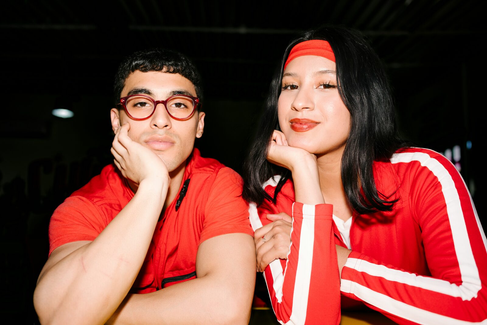 Virginia couple in matching red outfits in an editorial engagement portrait