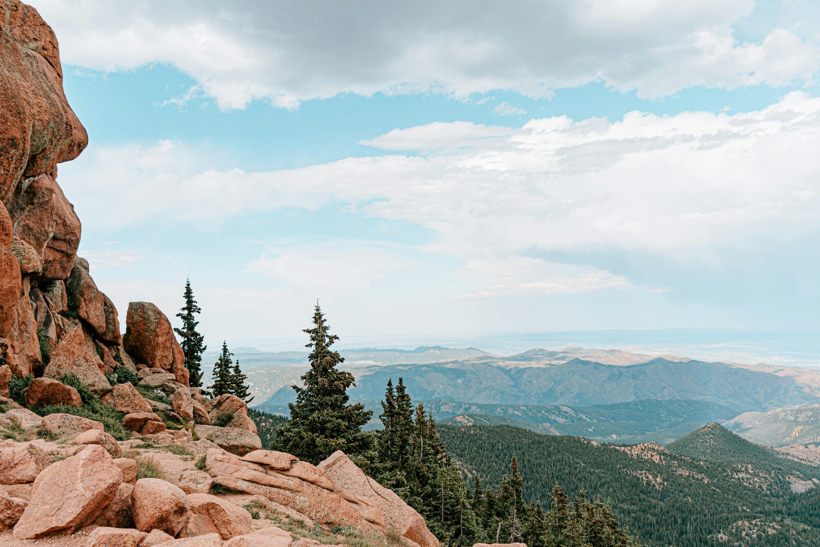 Pikes Peak Colorado mountain vista with red rocks and pine trees