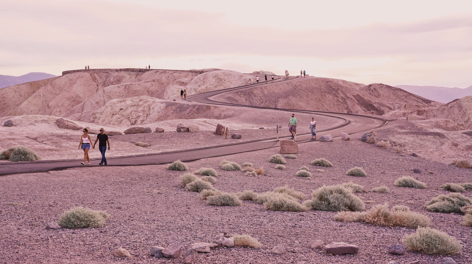Pink desert sunset over a winding path in Death Valley near Nevada
