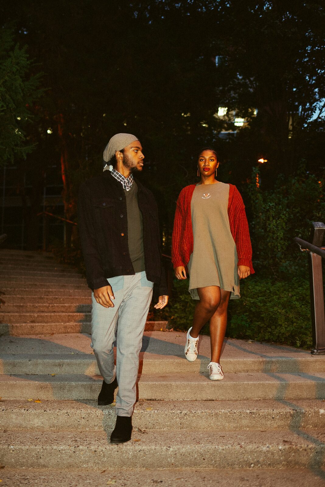 Stylish Michigan couple walking through the city at dusk, planning their future with a prenup