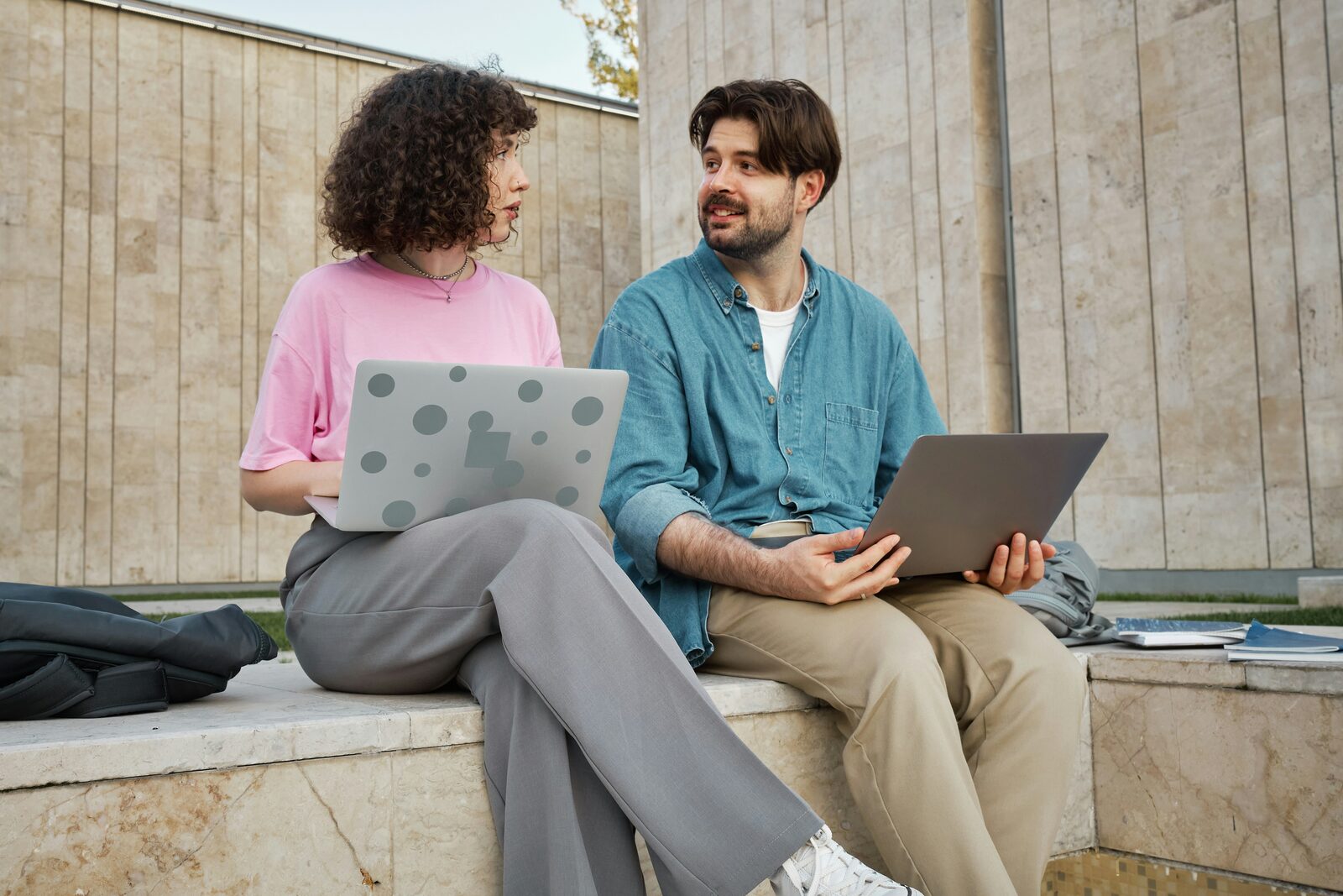Couple building their prenup together on laptops