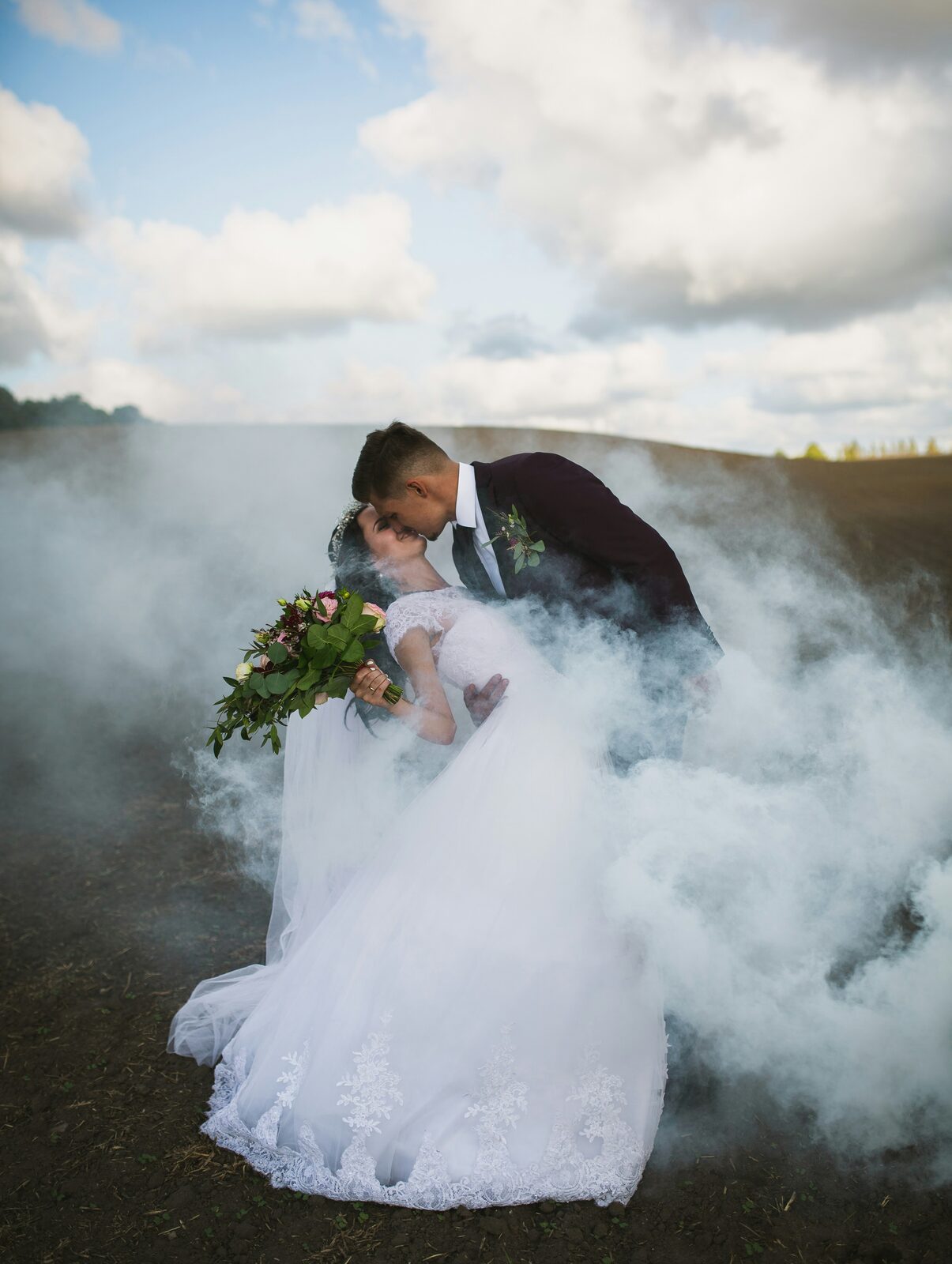 Oklahoma newlyweds sharing a dip kiss in an open field after completing their prenup