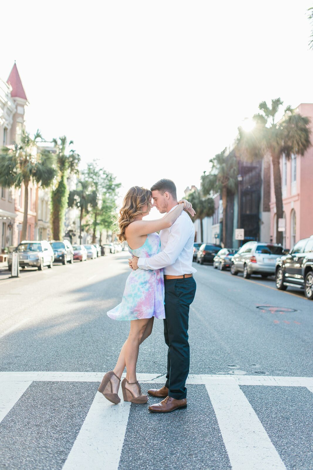 South Carolina couple embracing on a palm-lined Charleston street crosswalk, protected with a HelloPrenup prenuptial agreement