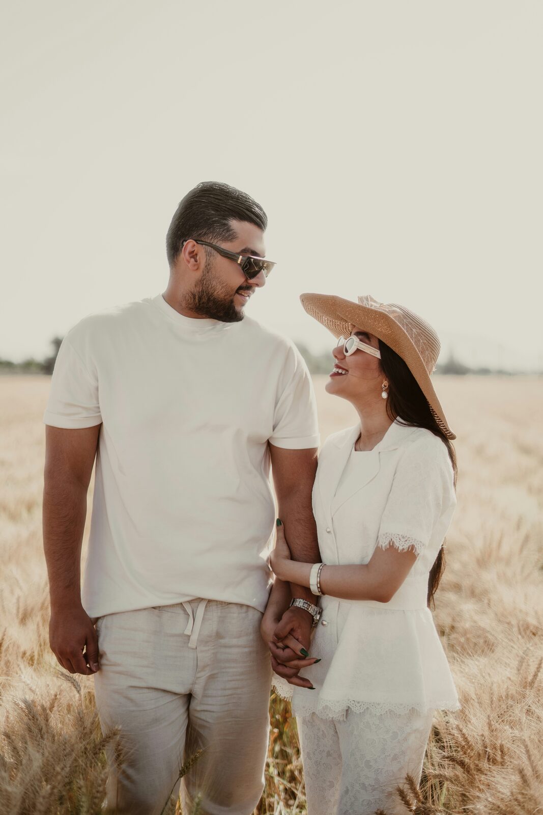 Maryland couple holding hands in a golden wheat field, protected with a HelloPrenup prenuptial agreement