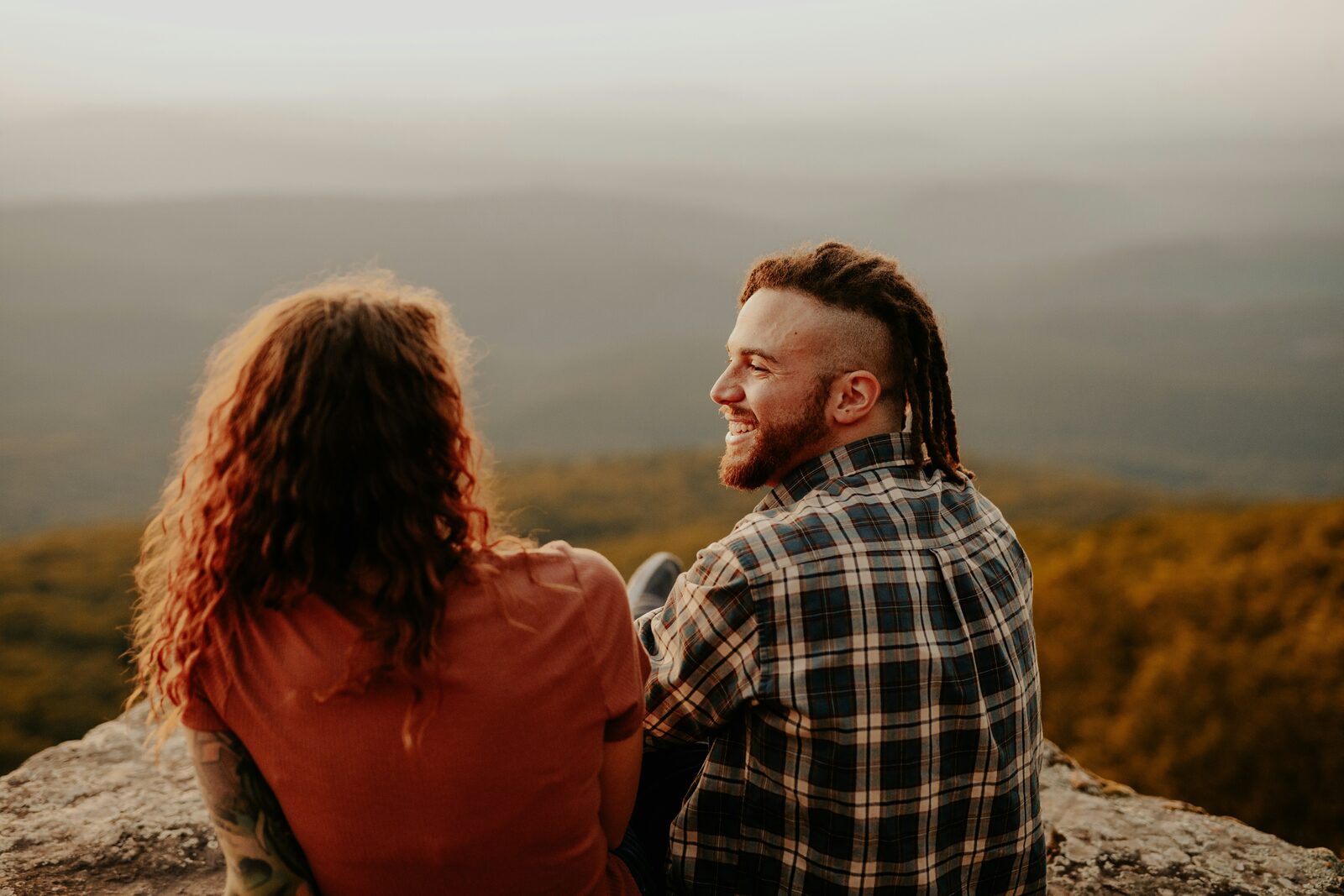 South Carolina couple laughing at a Blue Ridge mountain overlook at golden hour