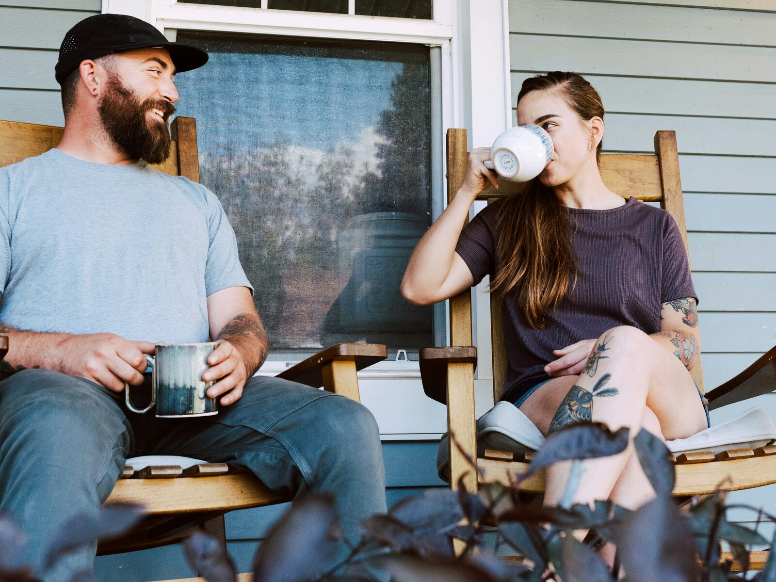 Minnesota couple sharing morning coffee in rocking chairs on their porch