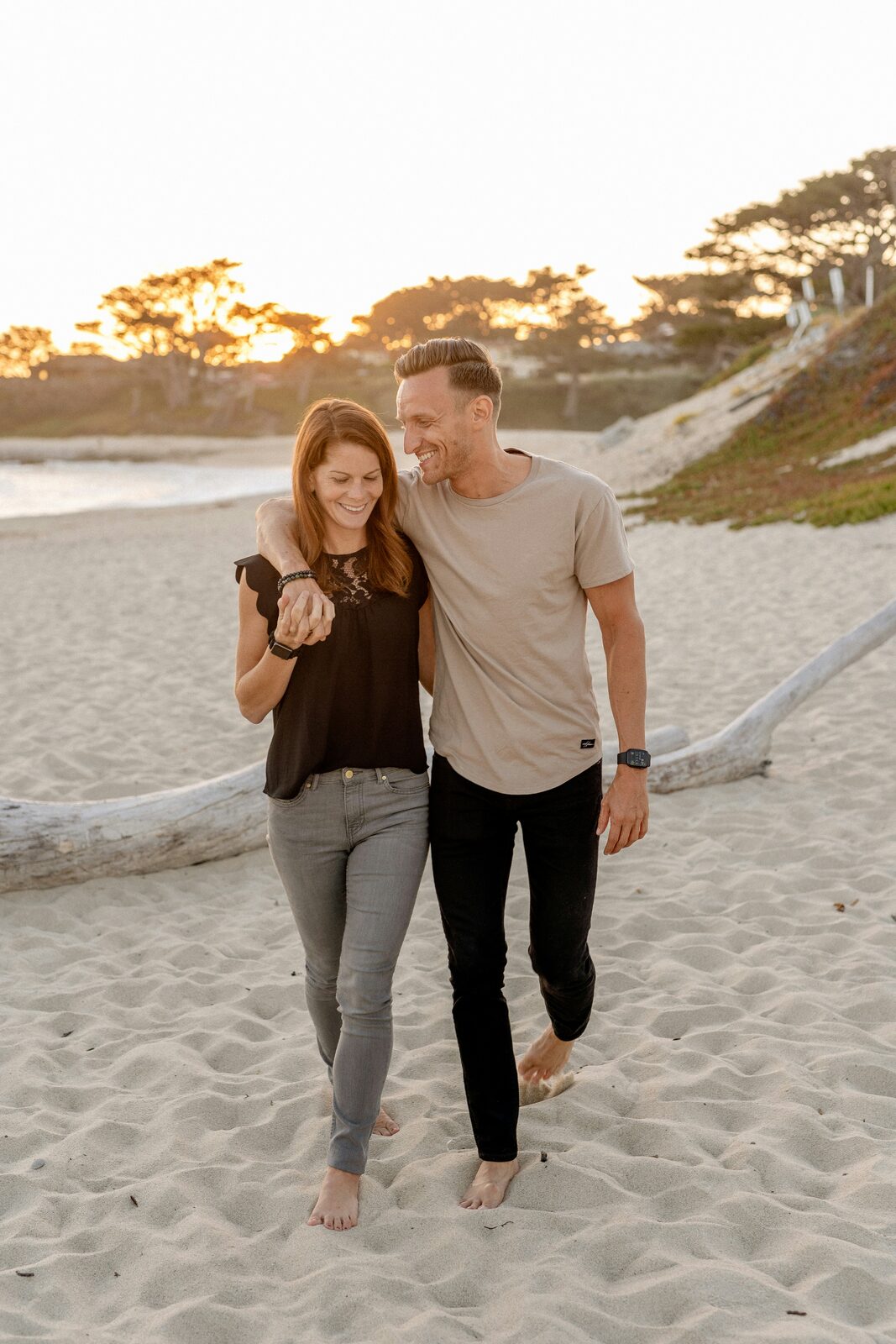Ohio couple walking barefoot on the beach at sunset, protected with a HelloPrenup prenuptial agreement
