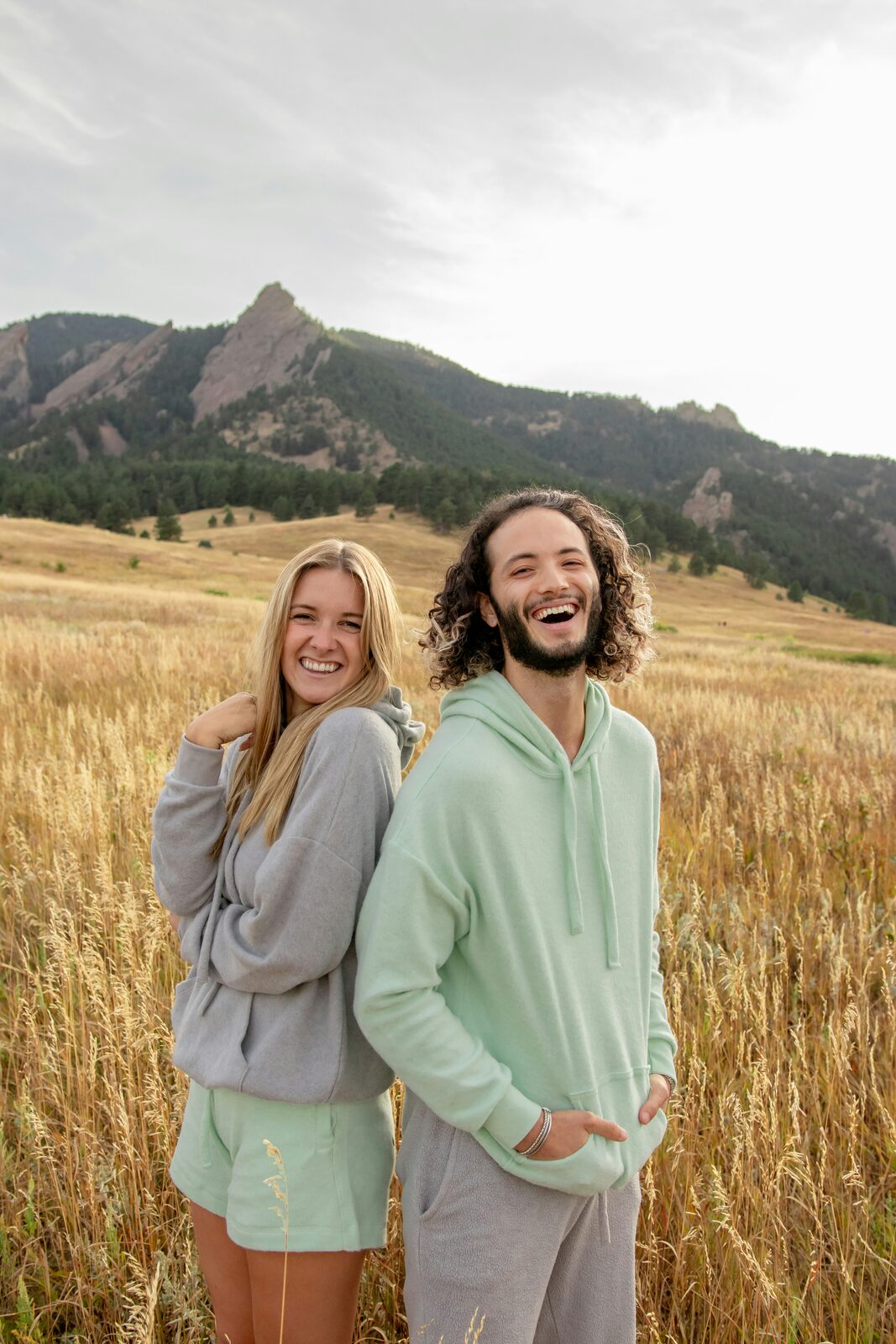 Maryland couple laughing together in a grassy field after completing their prenup