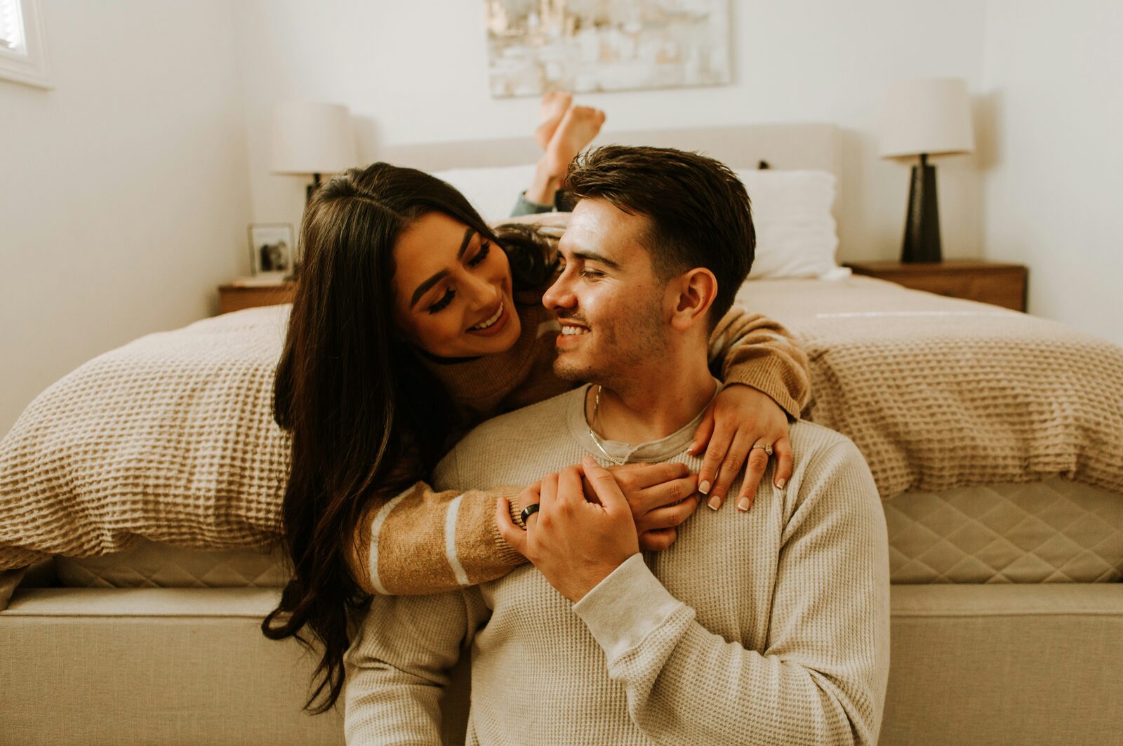 North Carolina couple hugging at home, engagement ring and wedding band visible, after completing their prenup
