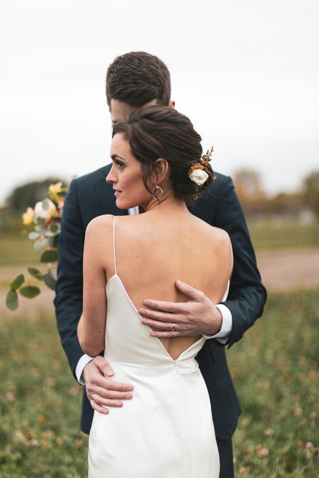 North Carolina bride and groom embracing in a silk slip gown and navy suit, protected with a HelloPrenup prenuptial agreement