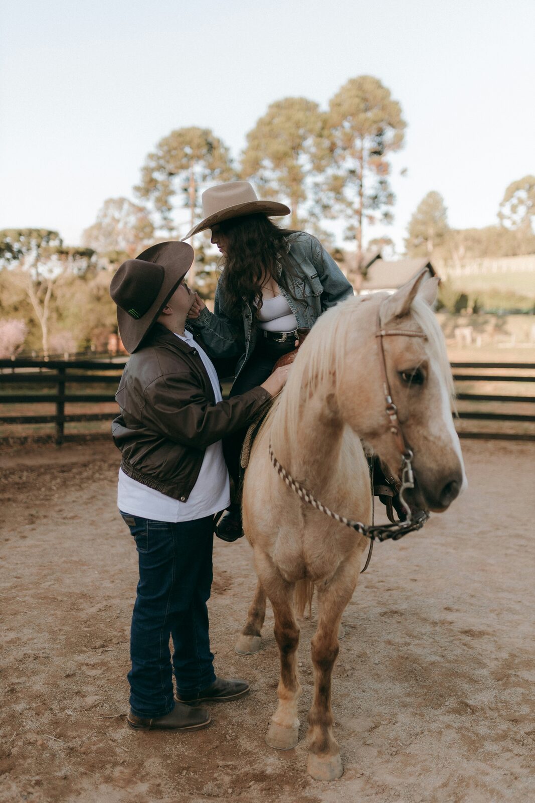 Tennessee couple in cowboy hats standing with a palomino horse, reflecting the property a prenup can protect