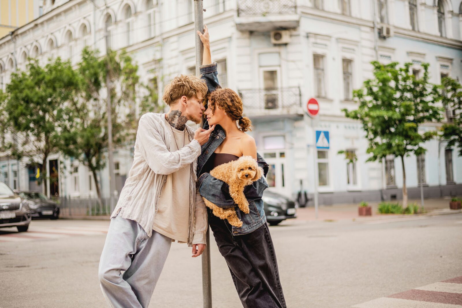 Minnesota couple walking their poodle puppy past a city lamp post