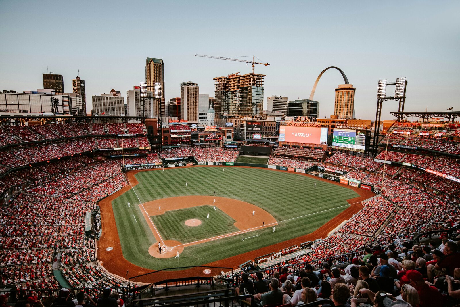 Busch Stadium in St. Louis during a Cardinals baseball game with the Gateway Arch on the skyline, where Missouri couples start their marriage on the same page with HelloPrenup