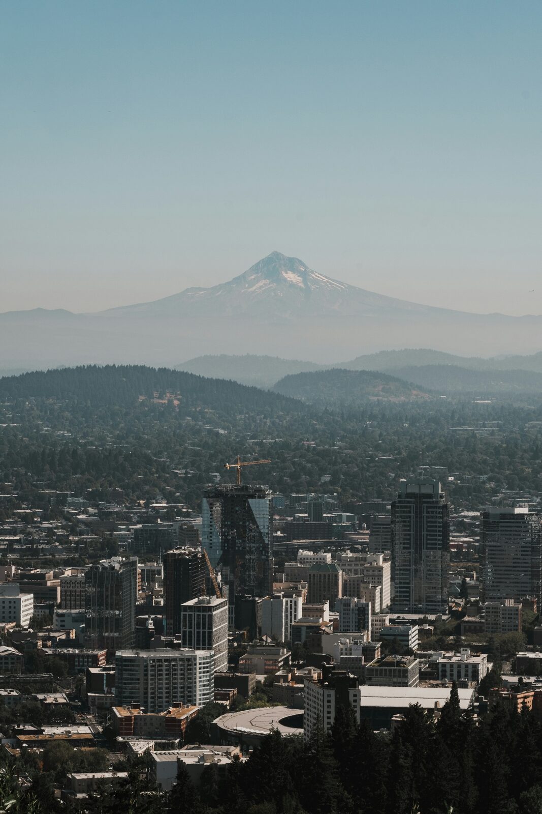 The downtown Portland skyline with Mount Hood behind it, seen from the Pittock Mansion viewpoint in Oregon