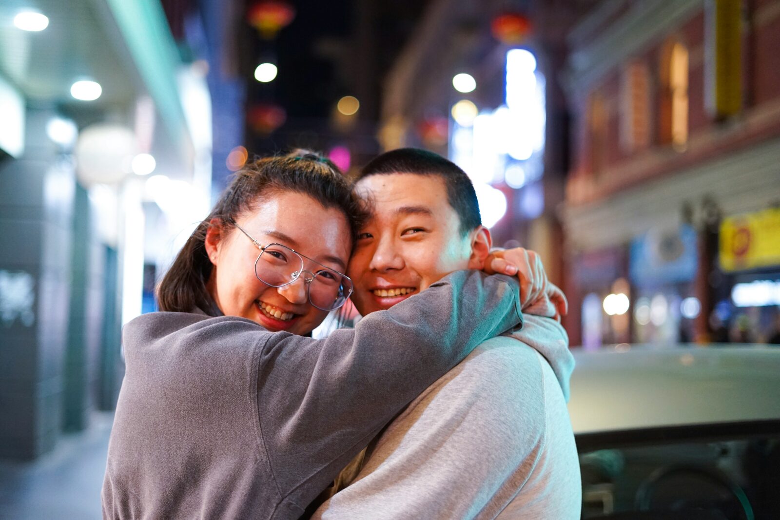 Engaged Louisiana couple hugging on a city street at night after finishing their prenup