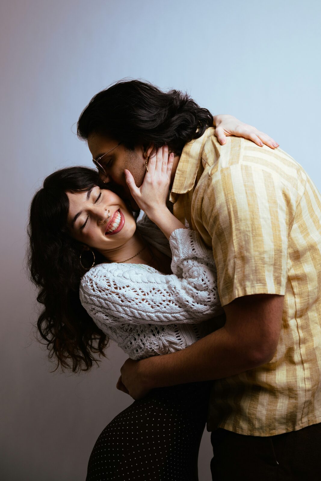 Engaged Louisiana couple laughing together while talking through their prenup options